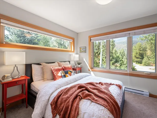 Bedroom featuring carpet floors and a baseboard heating unit