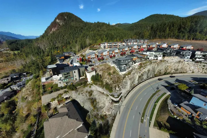 Aerial overview of property's location featuring nearby suburban area and mountains