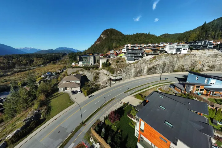 Aerial perspective of suburban area featuring a mountain backdrop