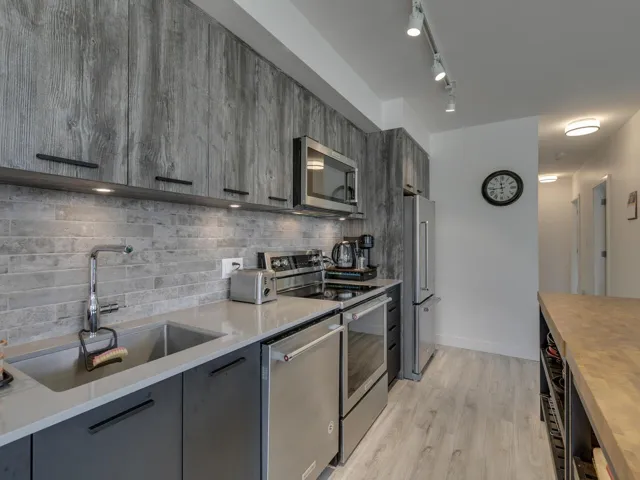 Kitchen featuring a sink, modern cabinets, tasteful backsplash, and stainless steel appliances