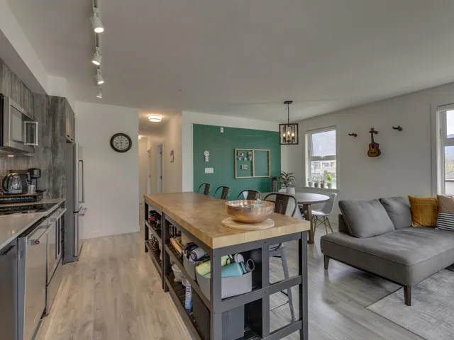 Kitchen featuring a healthy amount of sunlight, appliances with stainless steel finishes, and light wood-style flooring