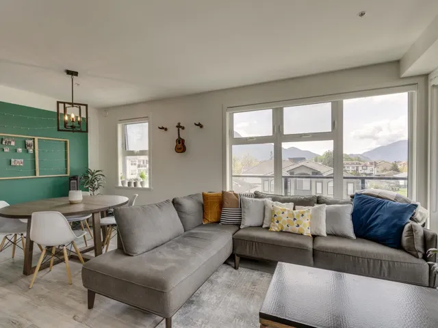 Living room with light wood-style floors and a chandelier