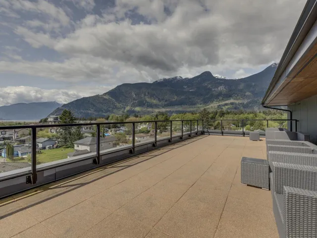 Exterior space with a mountain view, a balcony, and cooling unit
