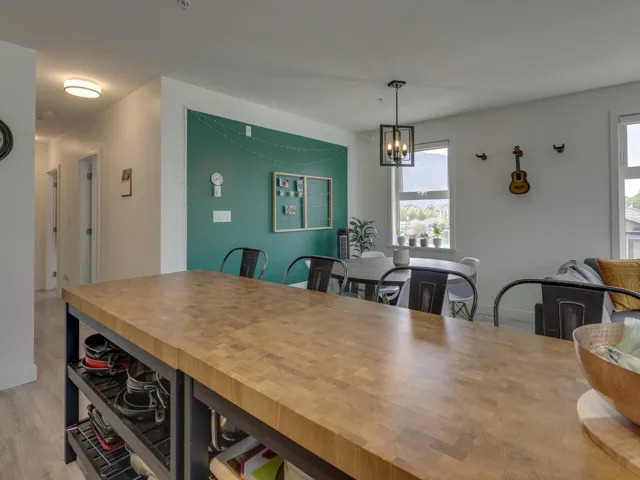 Dining area featuring baseboards, light wood-style flooring, and a notable chandelier
