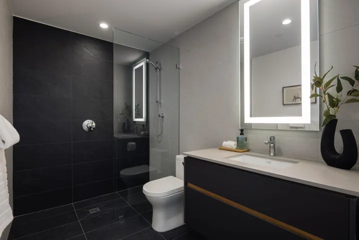 Bathroom featuring tile walls, vanity, dark tile patterned flooring, walk in shower, and recessed lighting