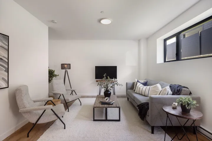 Living area featuring wood finished floors and baseboard heating