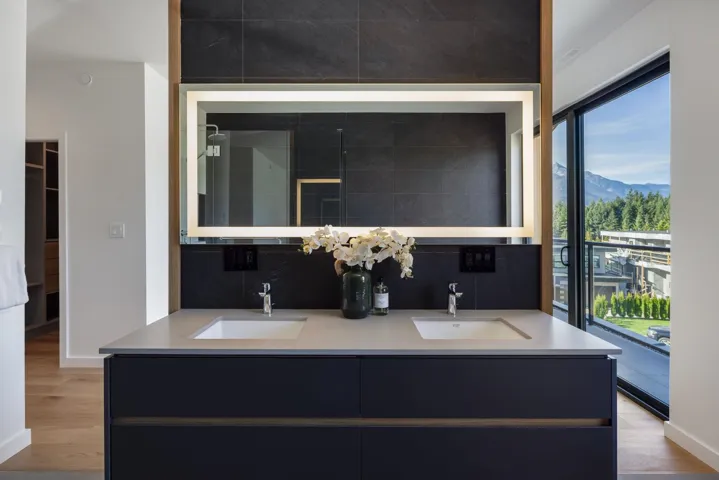 Full bath featuring light wood-style flooring, double vanity, and a mountain view