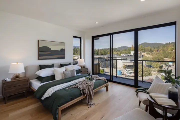 Bedroom featuring a mountain view, light wood-style flooring, access to outside, and recessed lighting