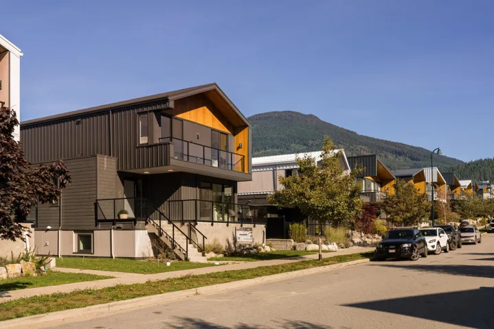 View of building exterior featuring a mountain view and stairs
