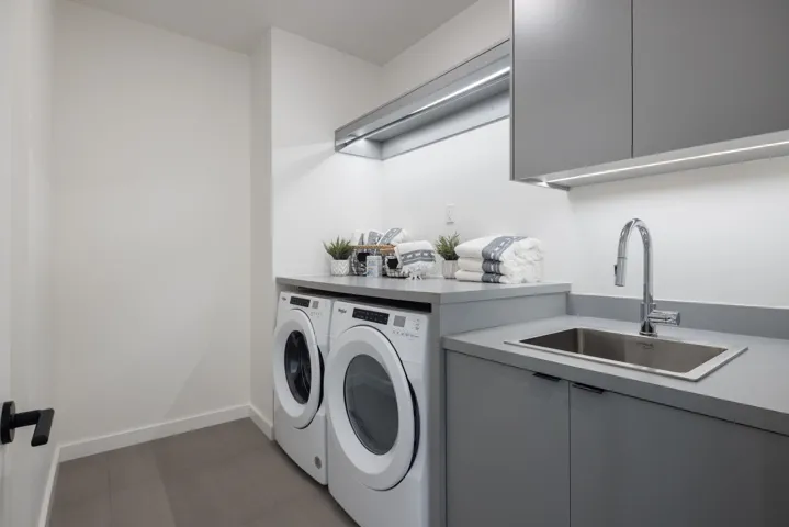 Washroom featuring cabinet space and washing machine and dryer