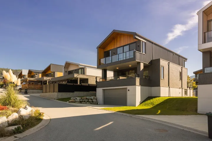 Modern home featuring a balcony, a residential view, and an attached garage