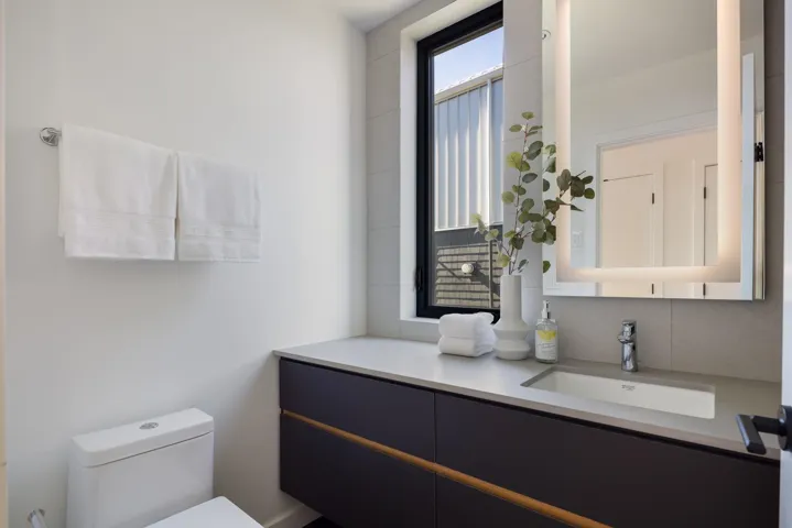 Half bathroom with vanity and toilet