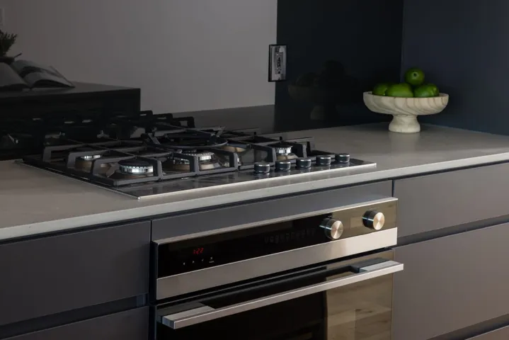 Kitchen view of appliances with stainless steel finishes, light countertops, and gray cabinetry