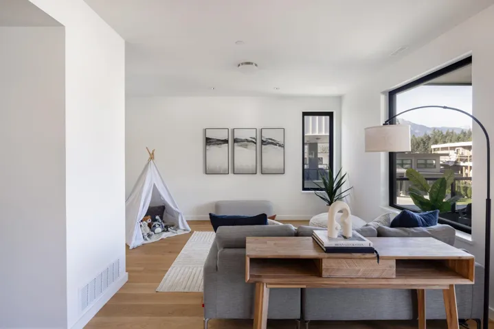 Living area with light wood finished floors and baseboards