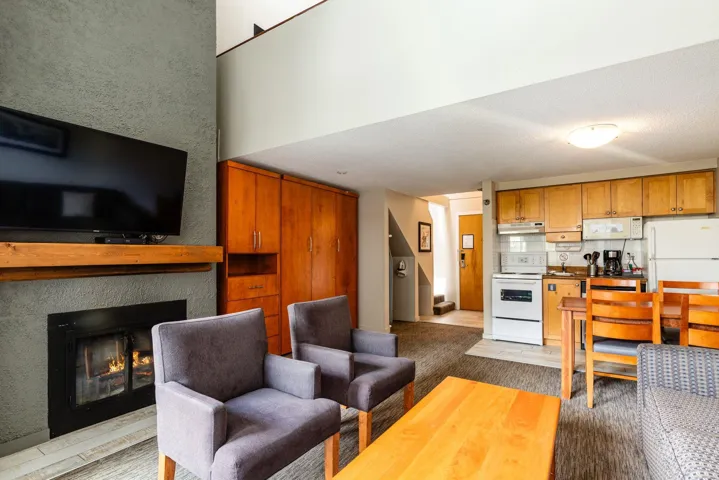 Living room with a lit fireplace