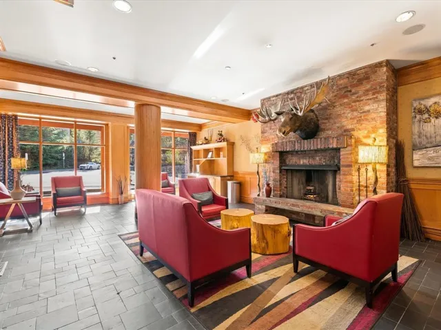 Building lobby with a wainscoted wall and recessed lighting