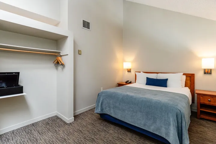 Bedroom featuring carpet and baseboards