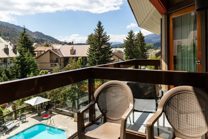 Balcony with a mountain view and view of pool