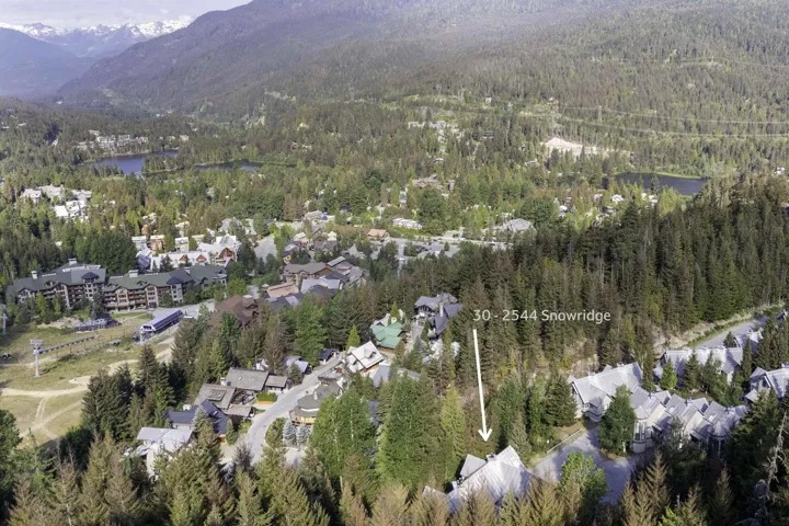 Aerial perspective showcasing a mountain community with dense forest surroundings