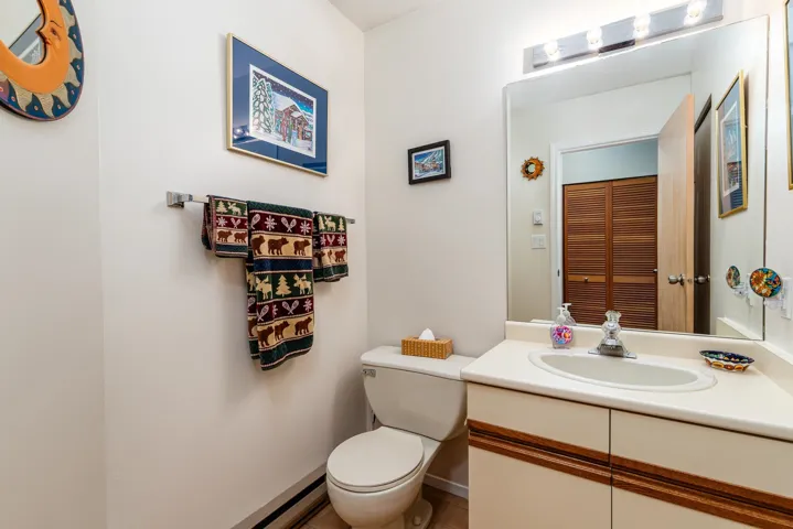 Bathroom vanity with an integrated sink, cream countertop, and chrome faucet