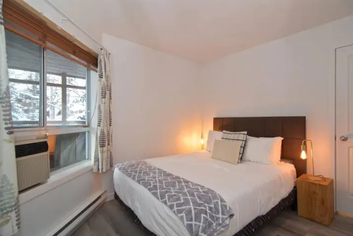 Bedroom featuring a baseboard radiator and wood finished floors
