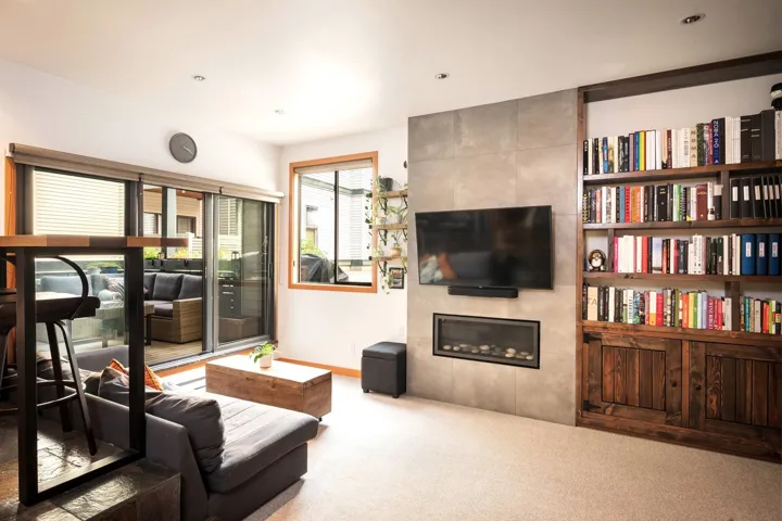 Carpeted living room featuring a fireplace and recessed lighting