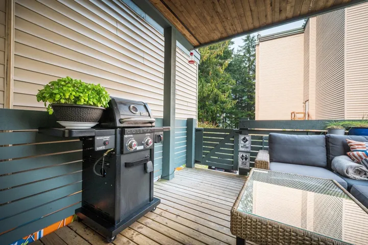 Wooden deck with grilling area and an outdoor living space