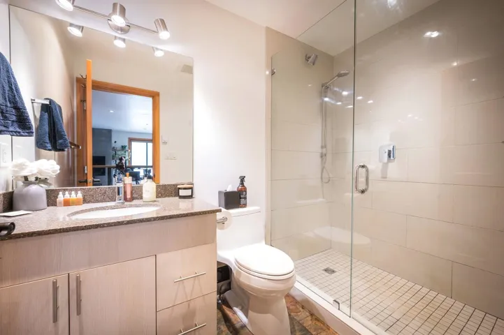 Bathroom with a shower stall and vanity
