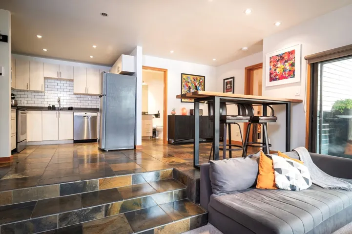 Living area with recessed lighting and stone tile floors