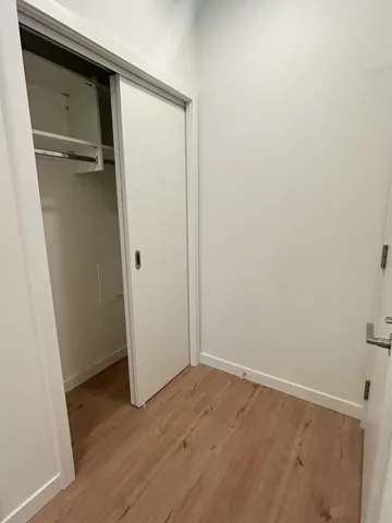 Unfurnished bedroom with a closet and light wood-style floors