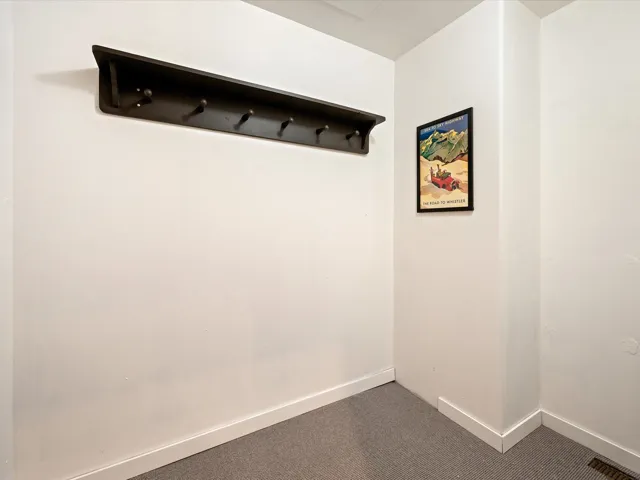 Mudroom featuring carpet and baseboards