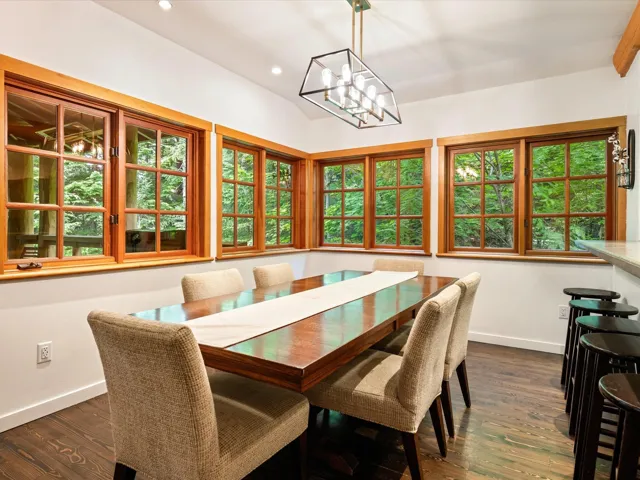 Dining space with recessed lighting, dark wood finished floors, a chandelier, and vaulted ceiling