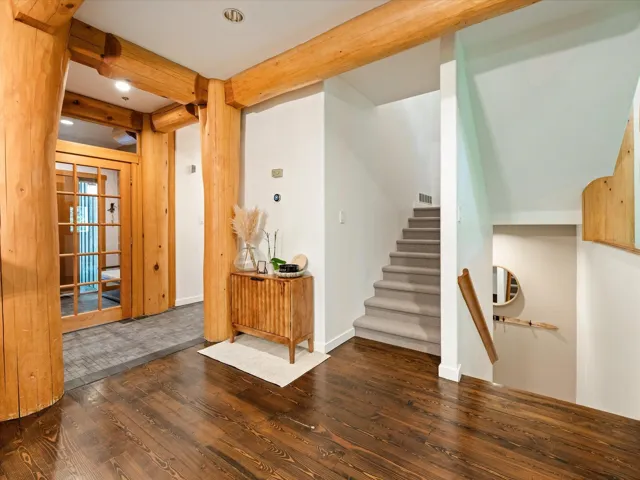 Foyer entrance featuring wood finished floors, beamed ceiling, stairs, and recessed lighting