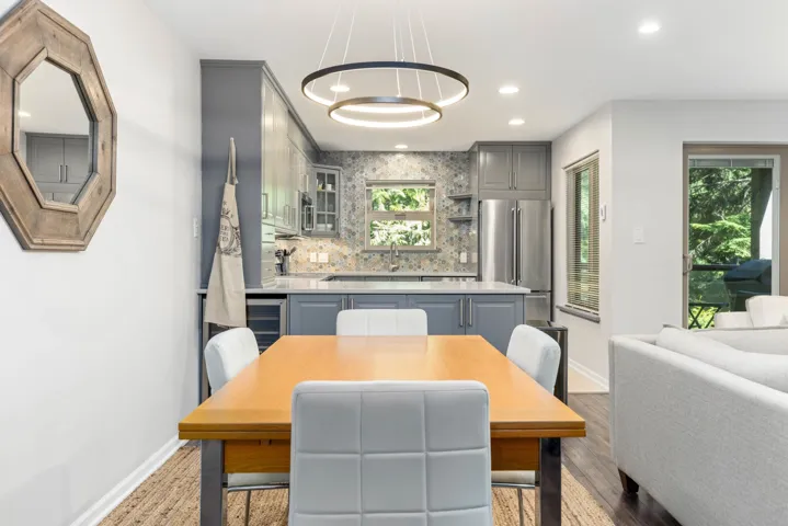 Dining room with baseboards, recessed lighting, beverage cooler, and wood finished floors
