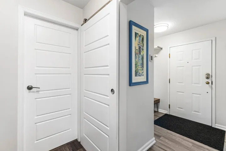 Hall featuring dark wood-type flooring and baseboards
