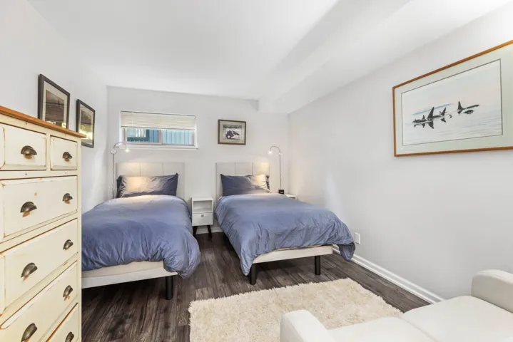 Bedroom featuring wood finished floors and baseboards