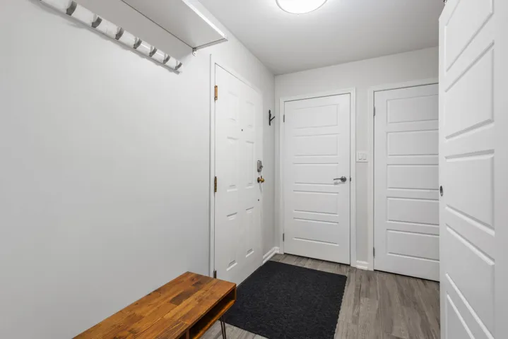 Doorway featuring wood finished floors and baseboards
