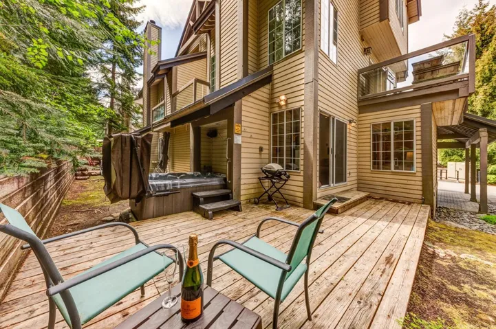 Wooden deck featuring a hot tub
