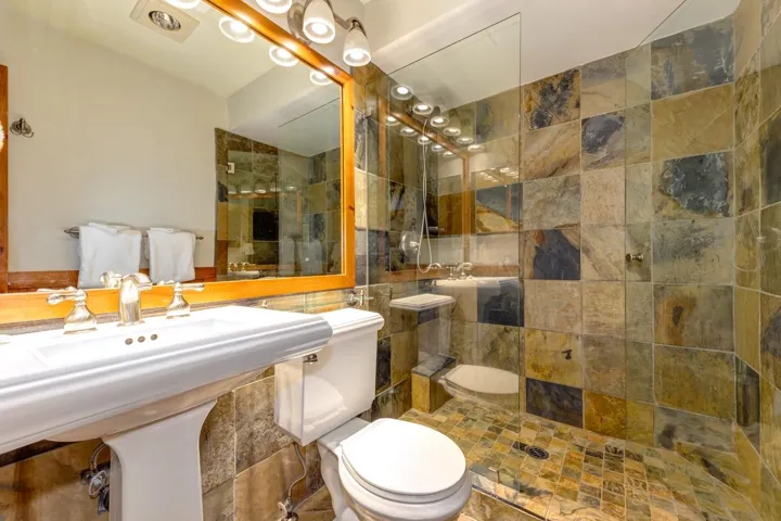 Bathroom featuring toilet and a tile shower