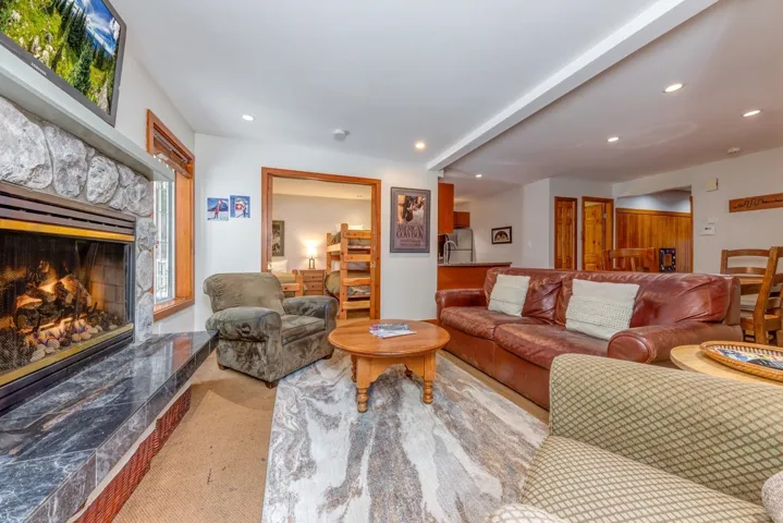 Carpeted living area featuring a high end fireplace and recessed lighting