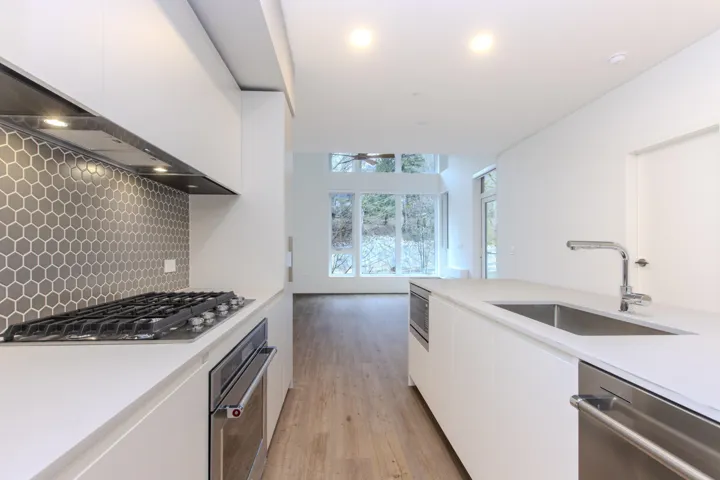 Italian kitchen by Inform features a gas cooktop, pull-out pantry, and integrated refrigerator