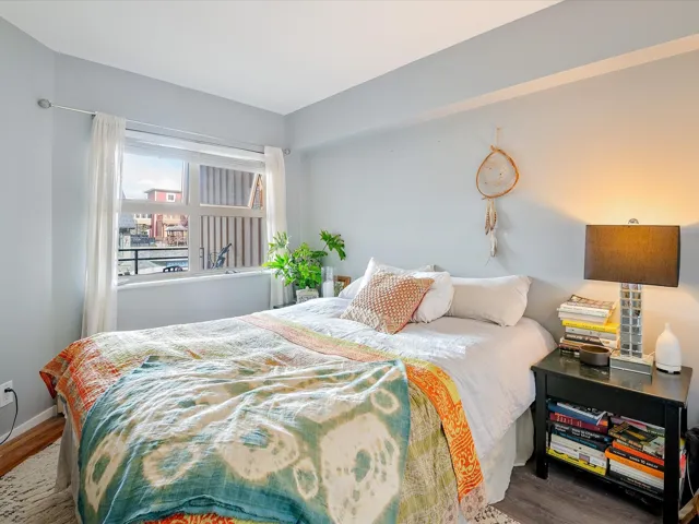 Bedroom with wood finished floors and baseboards