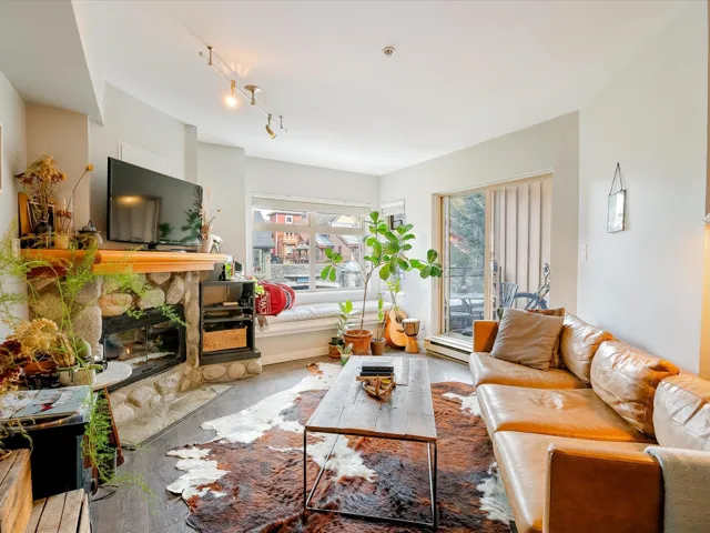 Living area featuring a fireplace, wood finished floors, and track lighting