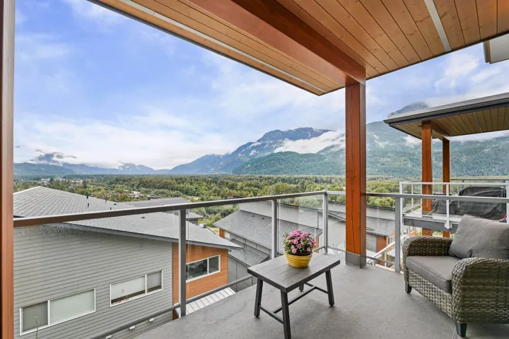 Balcony featuring a mountain view and a sunroom