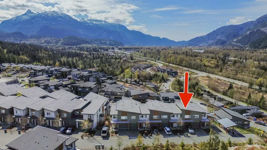 Aerial overview of property's location with a mountain backdrop and nearby suburban area