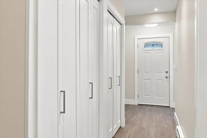 White paneled bifold closet doors with brushed nickel hardware