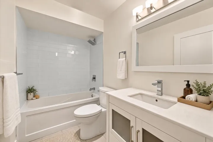 White subway tile shower surround with a built-in bathtub