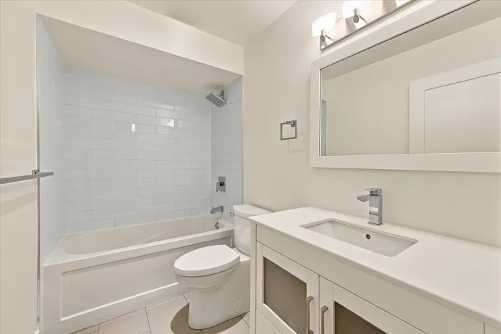 White subway tile shower surround with a rainfall showerhead