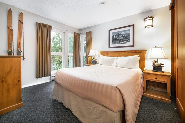 Bedroom featuring dark colored carpet and a textured ceiling