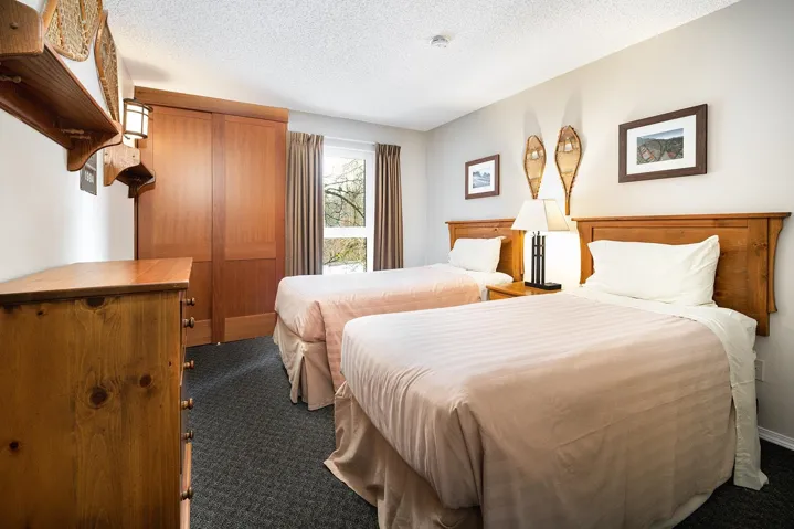 Bedroom with dark colored carpet and a textured ceiling